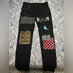 Black Amiri jeans with patches